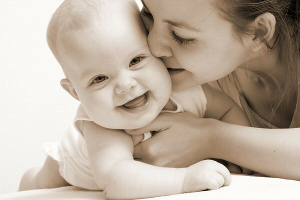 Mom kisses her baby