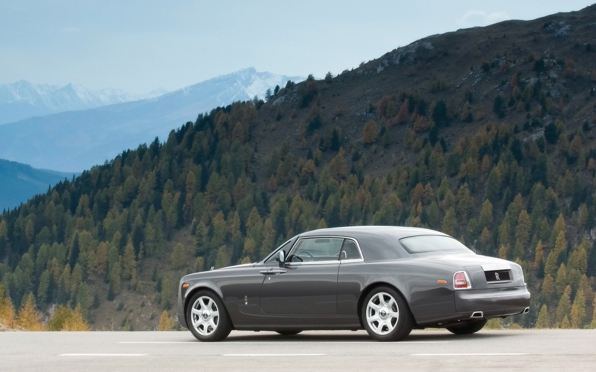 rolls royce car vehicle road travel transportation system landscape mountain blacktop asphalt noon