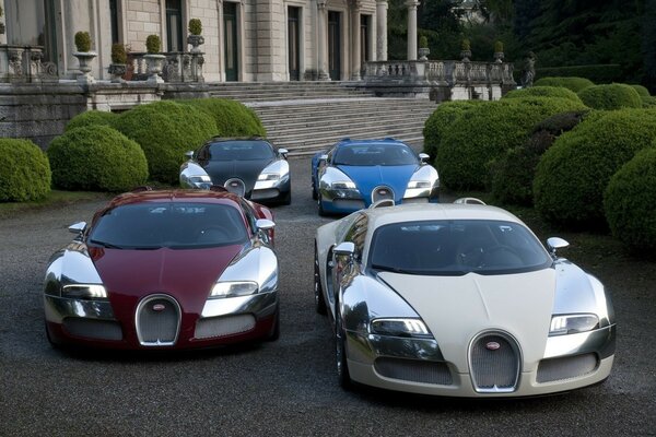 Four bugatti sports cars in a row