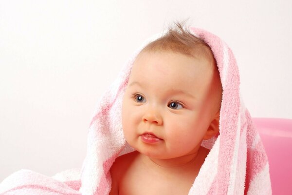 Cute baby in pink towel