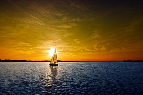 Yacht sur fond de coucher de soleil doré