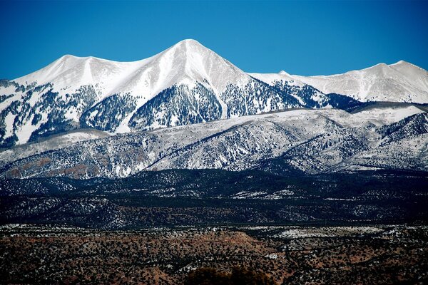 Snow-capped mountain peaks against the azure sky