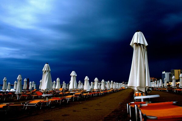 Sun loungers on the beach under the night sky