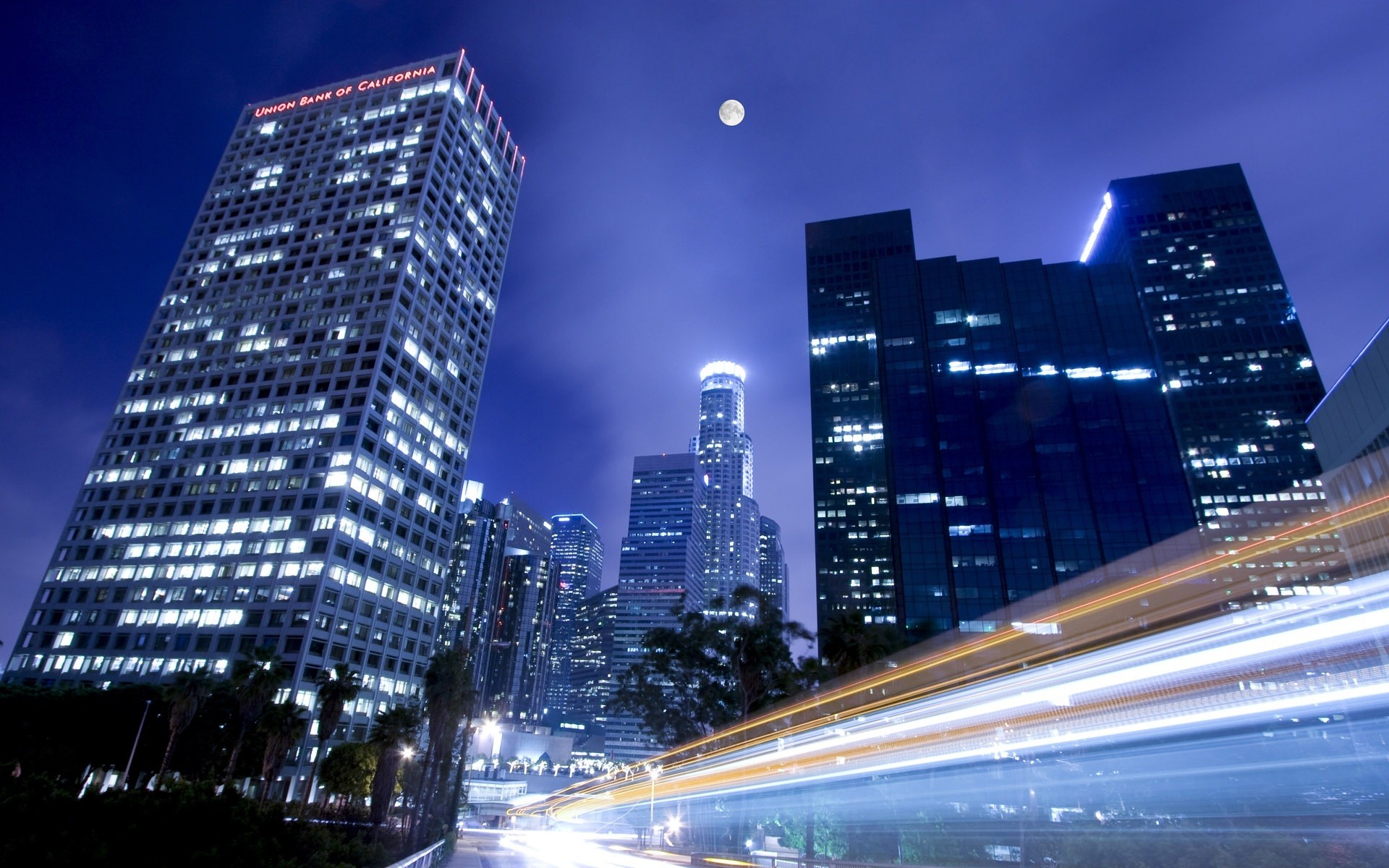 other city downtown skyscraper city architecture dusk cityscape skyline traffic building urban evening business illuminated travel fast sky modern blur road office night