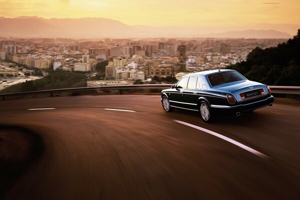 Sunset sky, road and bentley