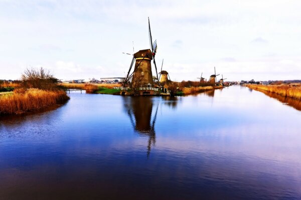 Reflection of a watermill on the surface of the water in the evening