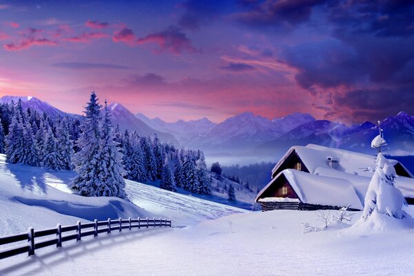 Maison dans la neige sur fond de montagnes