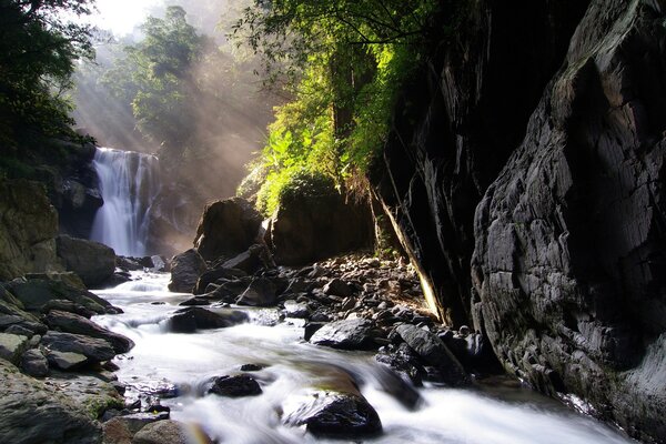 Rocky road to a low waterfall