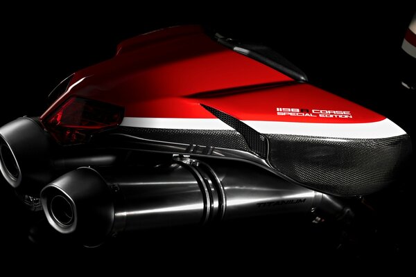 Part of a racing motorcycle on a black background