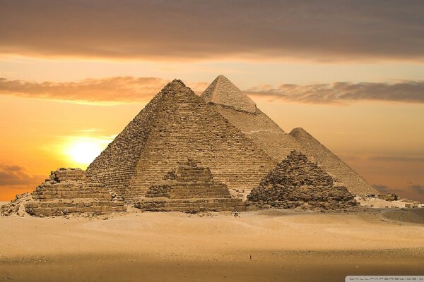 Ancient time-damaged pyramids at sunset