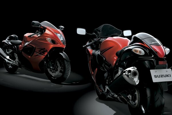 Two motorcycles on a black background