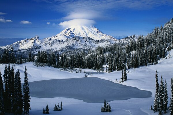 Mountain peak in the winter season. Snow-covered mountain peak in the azure sky