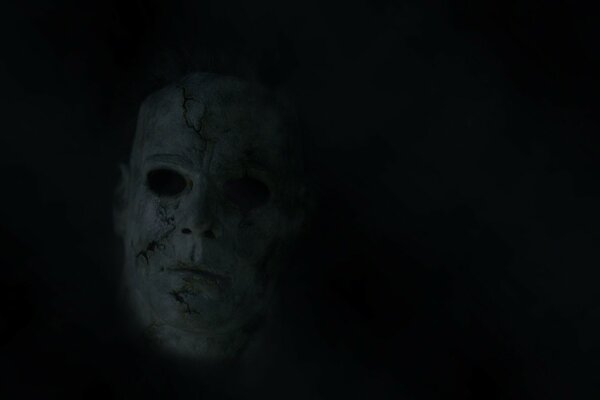 A scary mask in the dark without eyes