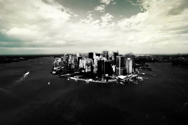 Monochrome photo of a city surrounded by water