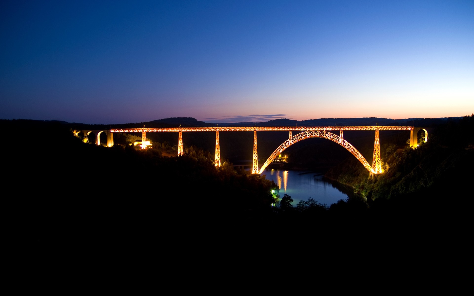 other city bridge sunset city water river sky architecture evening travel landscape dawn light dusk urban connection moon reflection silhouette sun background night lights