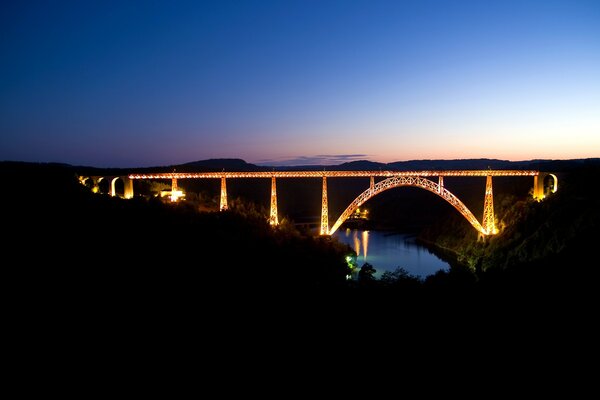 Illuminated bridge in the night darkness