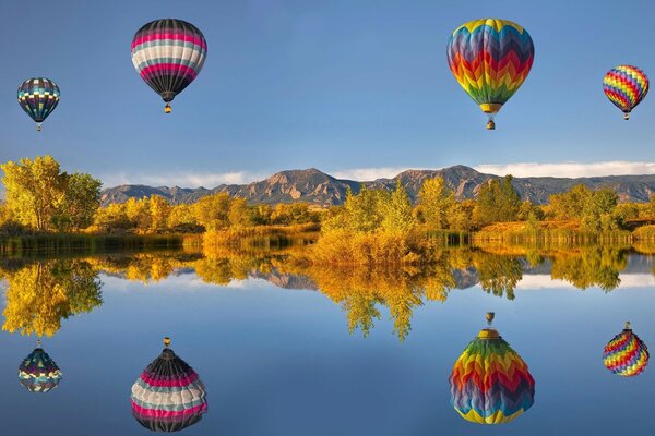 Balloons hovering over a calm lake