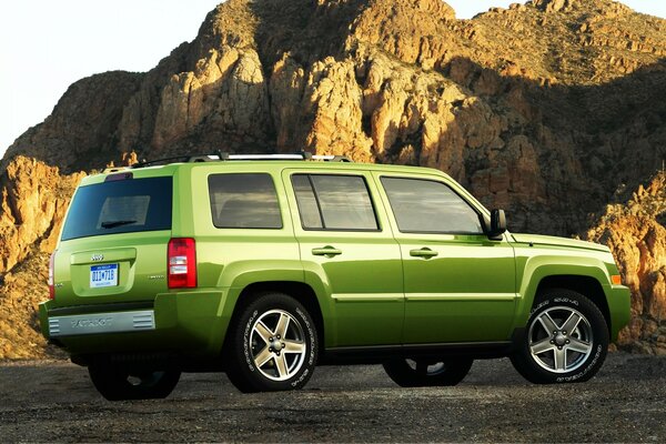 Green jeep on the background of mountains