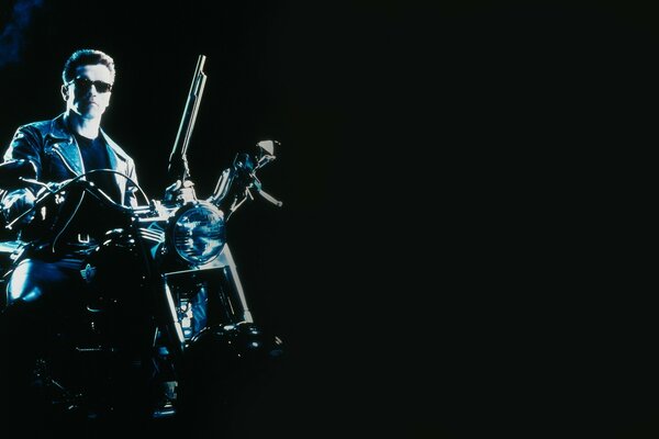 Terminator on a motorcycle in black background