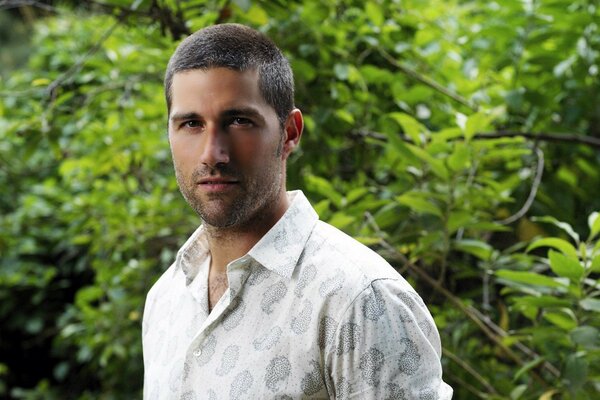 A man on a green background of foliage