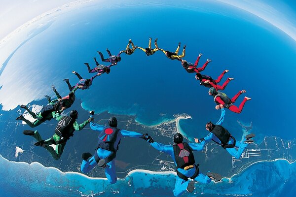 Group parachute jump on the background of the earth