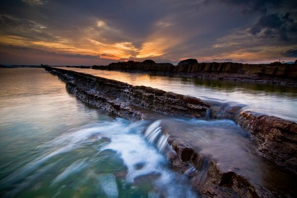 A river with rapids. Sunset. Waterfall