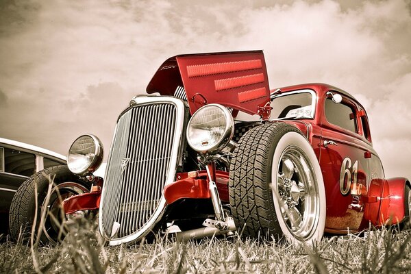 Red retro car with open hood