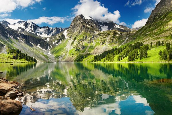 Mountains. Travel and mountains. Reflection in the water. Mountains in the snow