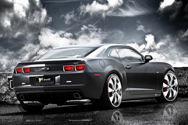 Grey Chevrolet and its reflection against the sky