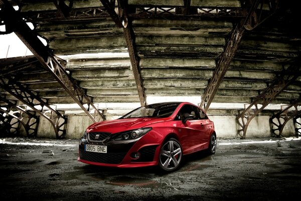 A red car in an abandoned building