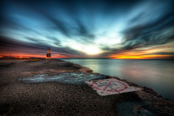 Ocean shore at sunset with a pendulum