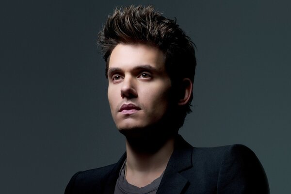 A handsome man in a suit on a gray background