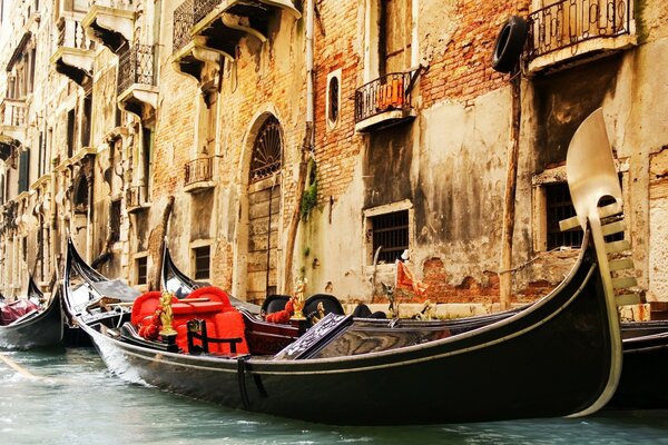 Parked gondolas on the background of an old building