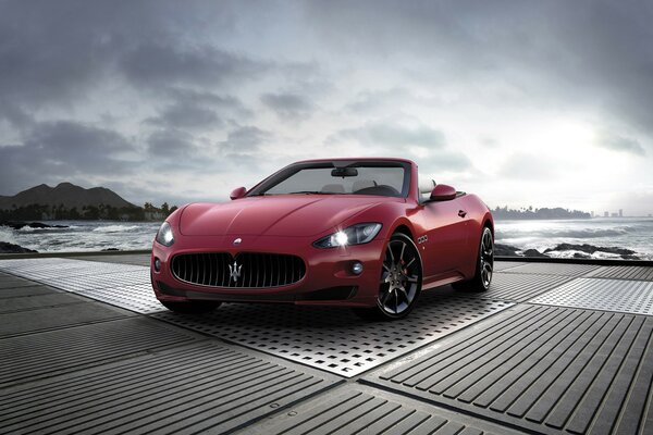 Red Maserati by the ocean