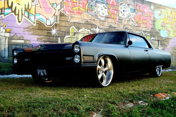 Black car on a background of colored graffiti