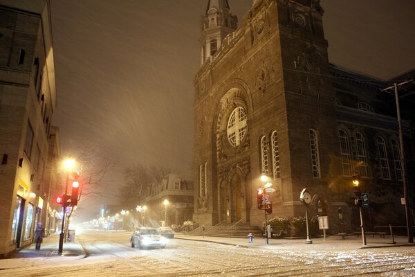 It s snowing outside. old architecture. evening city