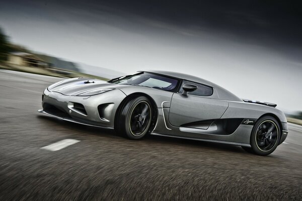 Gray sports car in a skid on the highway