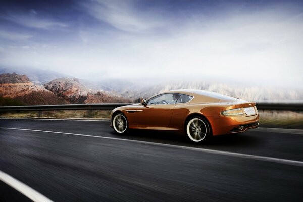 Aston Martin on the background of mountains