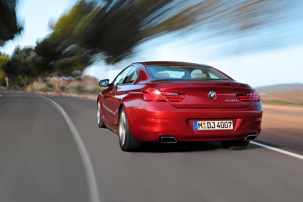 Vue arrière de BMW rouge avec fond flou