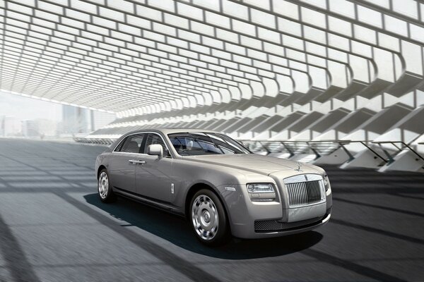 Silver Rolls Royce on the asphalt under a canopy