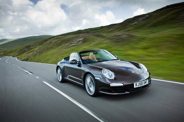 Porsche convertible in mountainous terrain