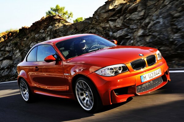 Bmw coupe on the highway with a rock