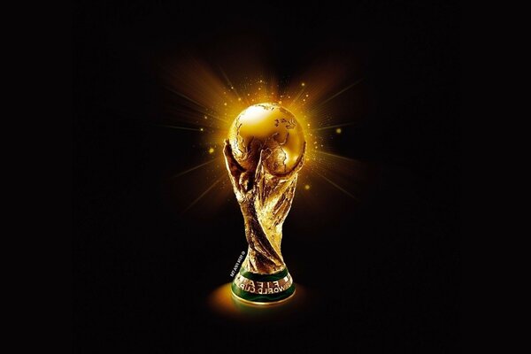 Золотой шар в темноте символ футбола