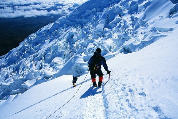 Climbing in the cold winter on a snow-covered mountain