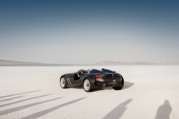 Coupe car on the sand with shadows