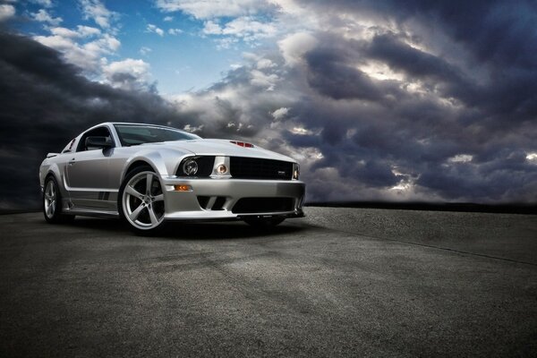 Gray car on a background of thick clouds