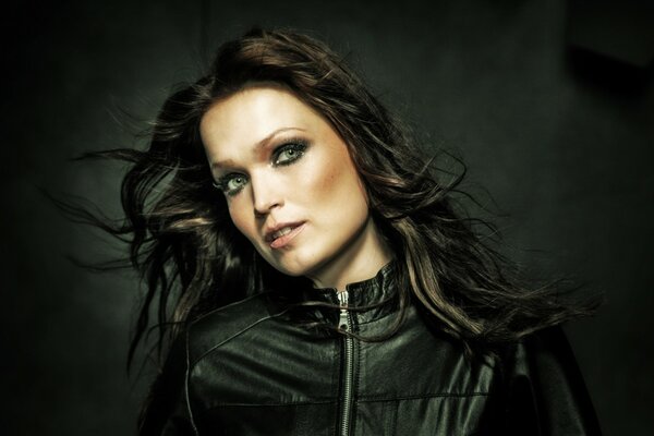 A model in a leather jacket on a black background