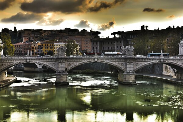 Bridge over the river in the city in cloudy weather