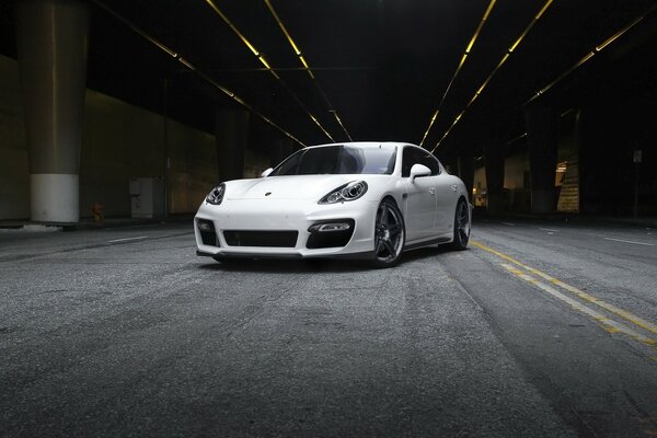 A white car shines in the parking lot