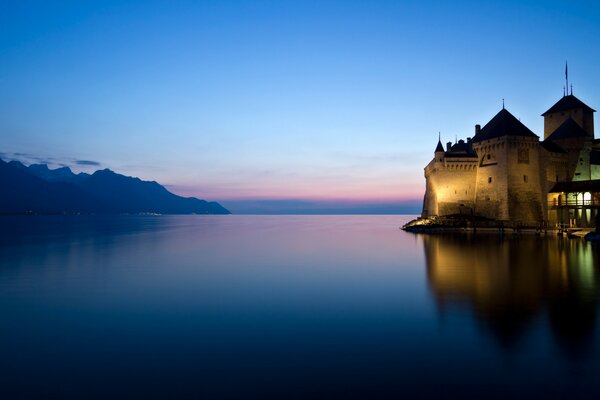 The castle by the lake In a pink sunset